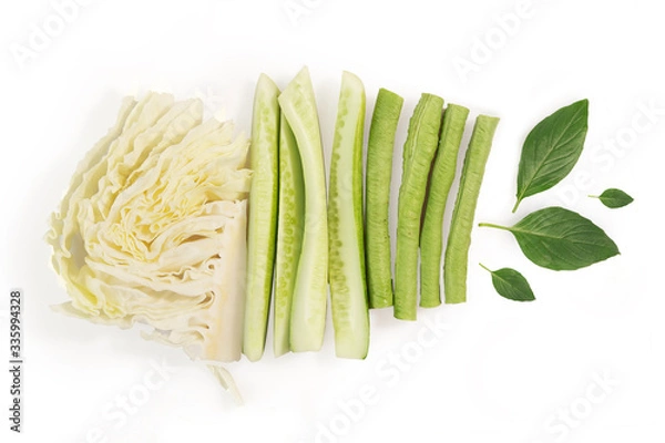 Fototapeta Vegetables, side dishes. Cabbage, cucumber, peas, basil. on white background. top view
