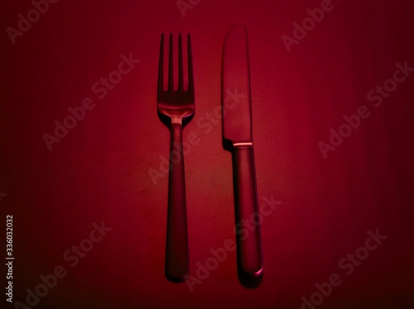 Fototapeta Knife and fork on a red beautiful background. You can change the color.