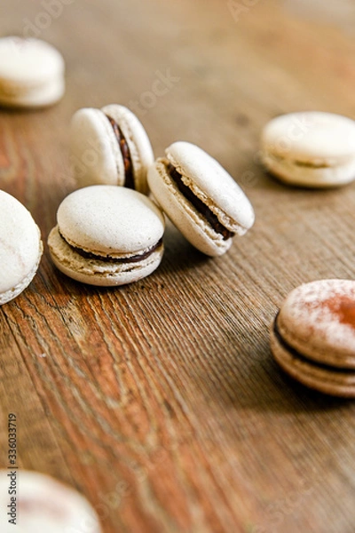 Fototapeta Several pieces of delicious French cookie - macrons. Chocolate flavor.