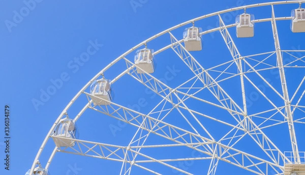 Fototapeta Ferris wheel in the blue sky . view the city from a height. entertainment on vacation .