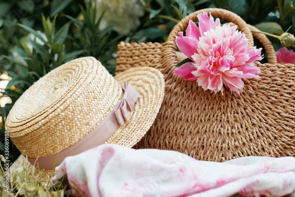 Fototapeta A picnic bag and straw hat, the concept of women's summer picnics