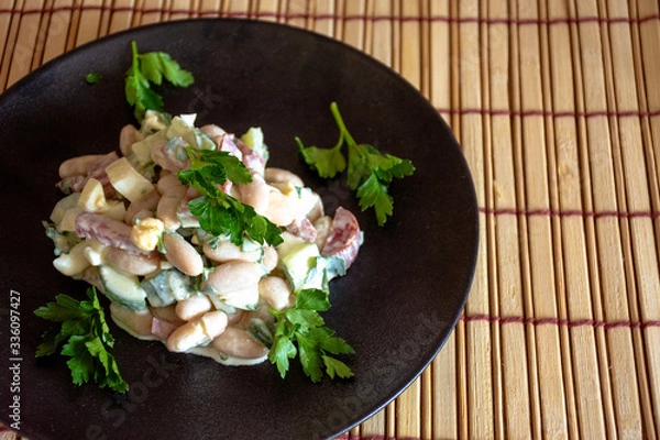 Fototapeta Salad with canned white beans and smoked sausage