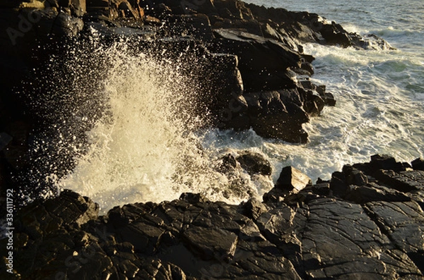 Obraz Waves splashing on the rocks on sunset