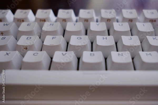Fototapeta Close and front view of a white mechanical keyboard focused in keys D F G H J