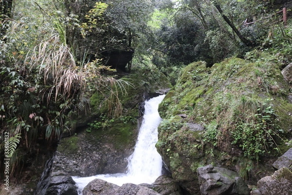 Fototapeta Beautiful landscape of a waterfall in a forest in a Mountain in Sichuan, China