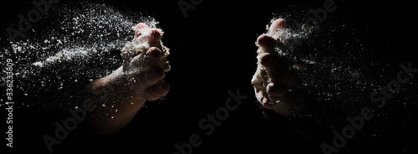 Fototapeta hands flapping flour in the dark. the flour is flying