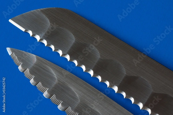 Obraz Two knife blades in blue background