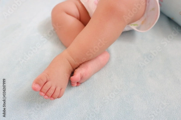 Obraz Baby's feet on blue background