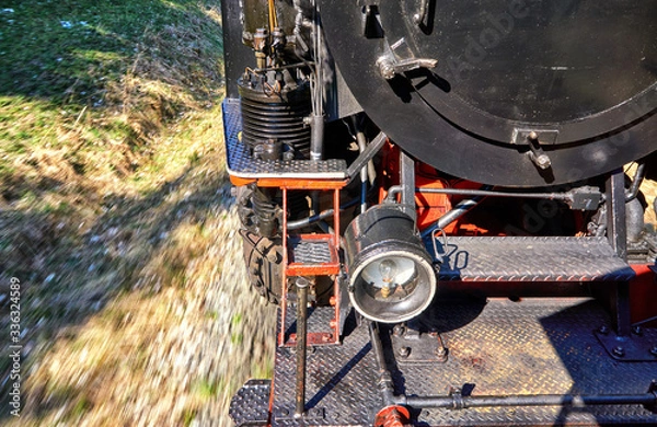 Obraz Detail of a steam locomotive while driving. Dynamics through motion blur.