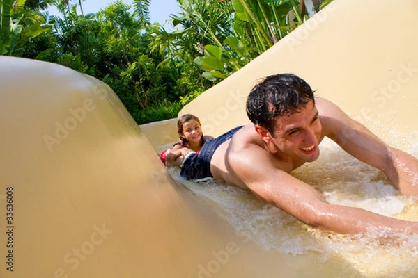 Obraz Father and Daughter Sliding Down Water Slide