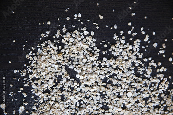 Fototapeta Raw oats on bark background