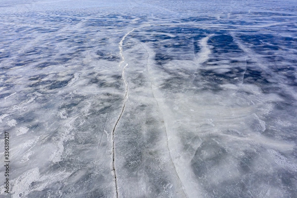 Fototapeta Aerial view of frozen lake. Ice from drone view. Background texture concept.
