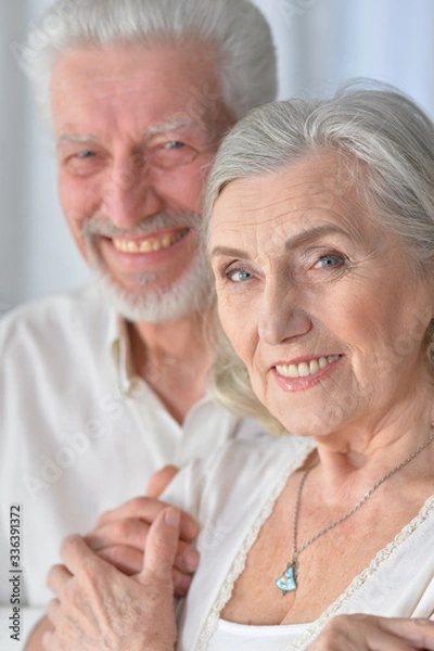 Obraz Portrait of senior couple hugging at home