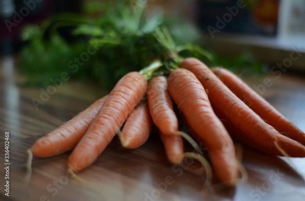 Obraz orange carrots on a table in the kitchen
