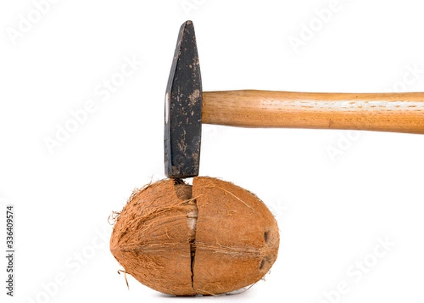 Obraz hammer and broken coconut on a white background