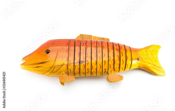 Fototapeta Light brown wooden fish on a white isolated background. Handmade carved from wood. An original souvenir for the fisherman.