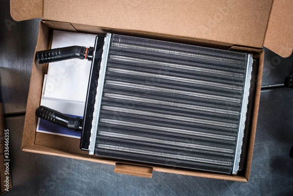 Fototapeta New car cooling radiator in box with documents