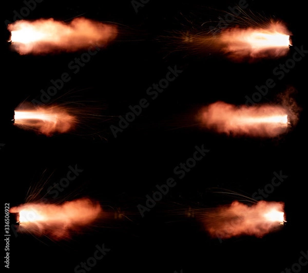 Obraz A shot from a firearm on a black background, a fiery exhaust with flying sparks, flames bursting out of the pipe