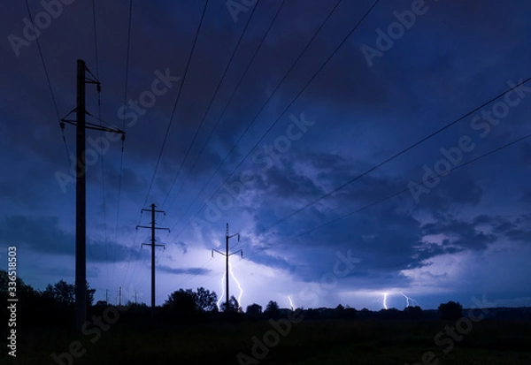 Obraz Silhouette of power lines on thunderstorm with lightnings background