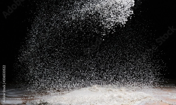 Obraz illuminated flour flakes and splits on a dark background
