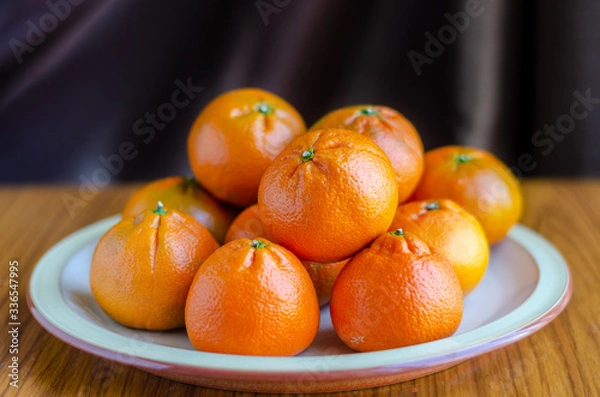 Obraz Mandarin oranges piled up on a plate.