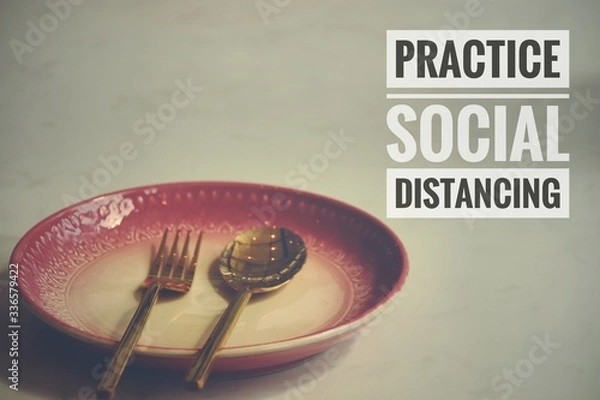 Fototapeta Conceptual still life photo of empty plate with cutlery with the message promoting social distancing, self isolation and home quarantine to prevent the spread of covid-19 pandemic