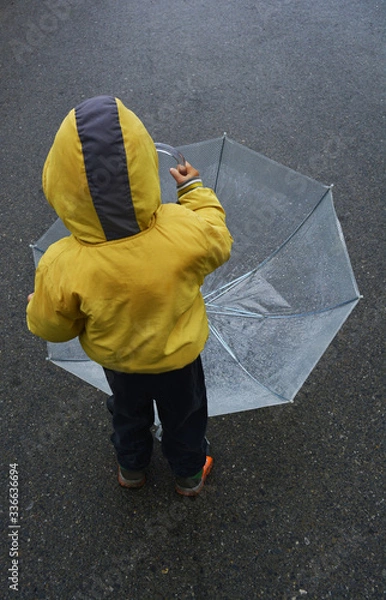 Obraz a small boy went for a walk with an umbrella in rainy weather