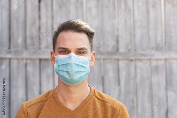 Fototapeta Young man with surgical mask