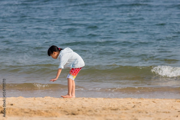 Fototapeta 海水浴場で砂遊びをしている可愛い子供