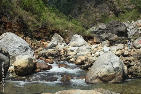 Obraz Mountain riverbank full of stones and greenery