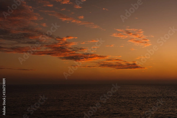 Fototapeta Amazing landscape Beautiful views of a sunset on the beach in front of the sea with clouds orange