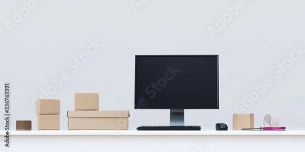 Fototapeta Clean white office desk in with computer boxes and scissors.