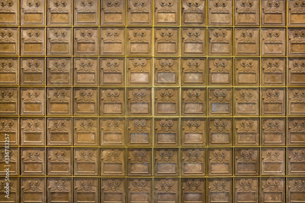 Fototapeta A wall of old PO post office mail boxes