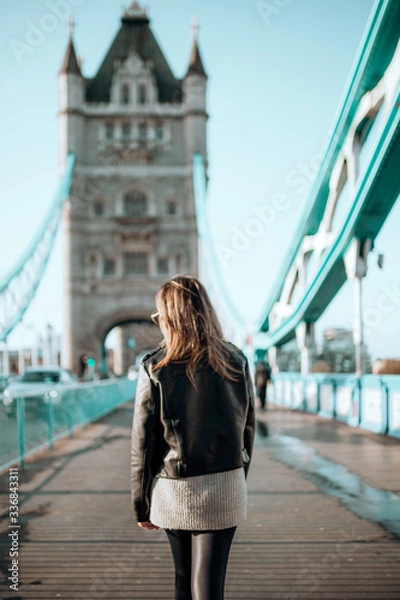 Fototapeta Girl walking on tower bridge on a beautiful blue sky day
