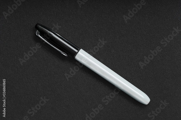 Fototapeta Black Sharpie on Black Textured Background Office Supplies 