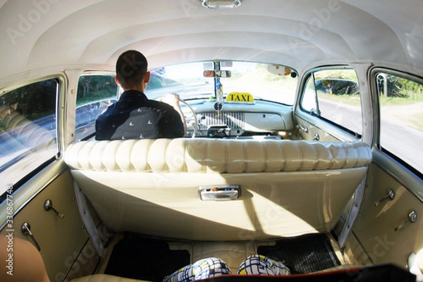 Fototapeta On the way to Vinales valley from Havana inside a classic car from the 1950s

