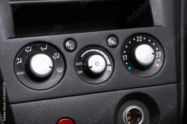 Fototapeta close up of  car panel with the air conditioning button inside a car..