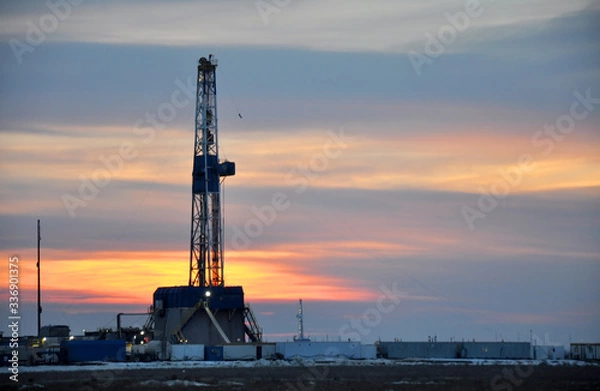 Fototapeta The drilling rig during sunset