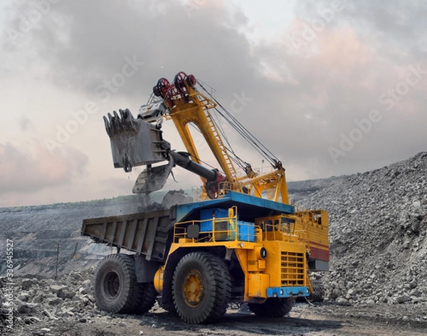 Obraz Loading of iron ore on very big dump-body truck