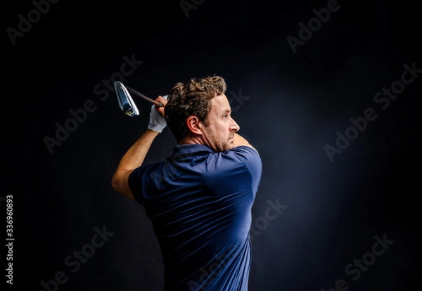 Fototapeta Close-up of a golf player intent on perfecting the swing