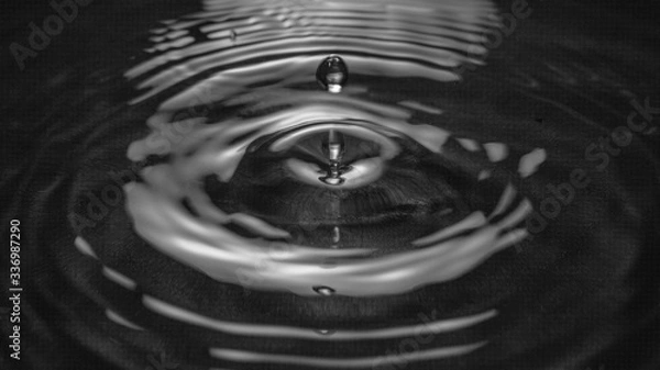 Obraz Drop of water falling and creating ripples, feeling of calm and tranquility.
