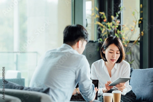 Fototapeta Young Asian business man and woman