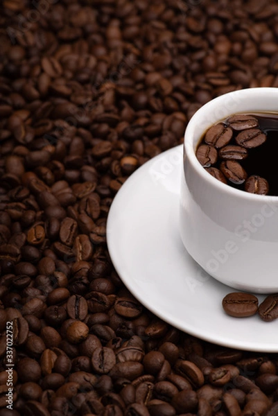 Obraz Cup with coffee beans on a dark background