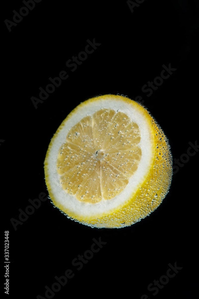 Fototapeta lemon slice on black