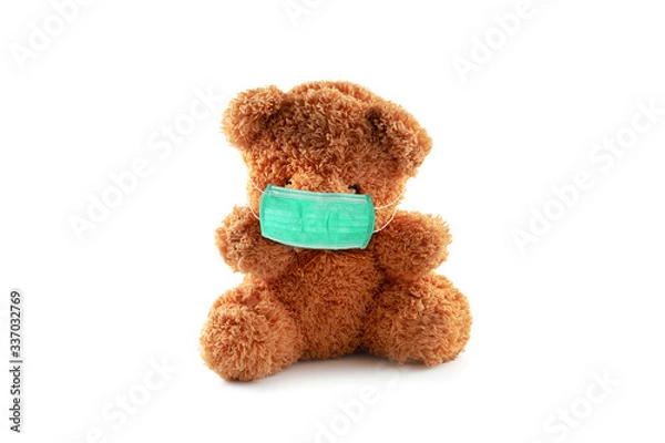 Obraz covid 19 concept.lonely brown bear doll with health face mask on white background  isolate