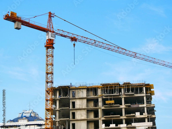 Obraz Tower crane near building. Construction site.
