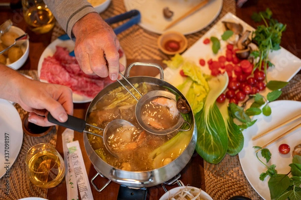 Obraz Hot pot cooking at home with Japanese Wagyu beef, shrimp and vegetables