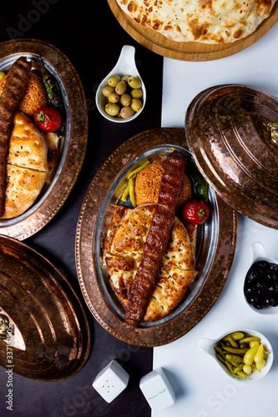 Fototapeta top view of adana kebab served on tandoor bread and bulgur
