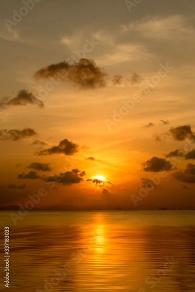 Fototapeta Sunset sky with dark clouds above the lake in golden time.