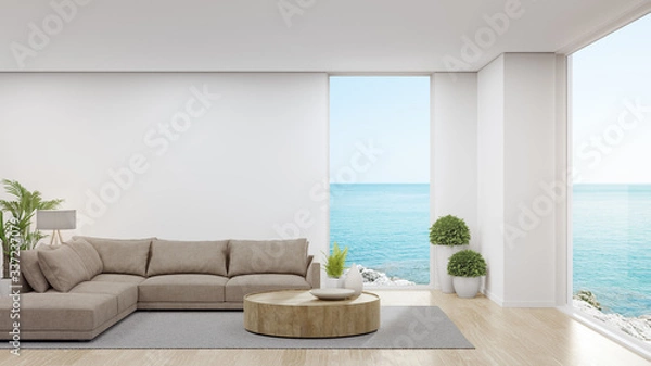 Fototapeta Sofa na drewnianej podłodze dużego salonu w nowoczesnym domu lub luksusowym hotelu. Minimalne renderowanie 3d wnętrza domu z widokiem na niebo i morze.